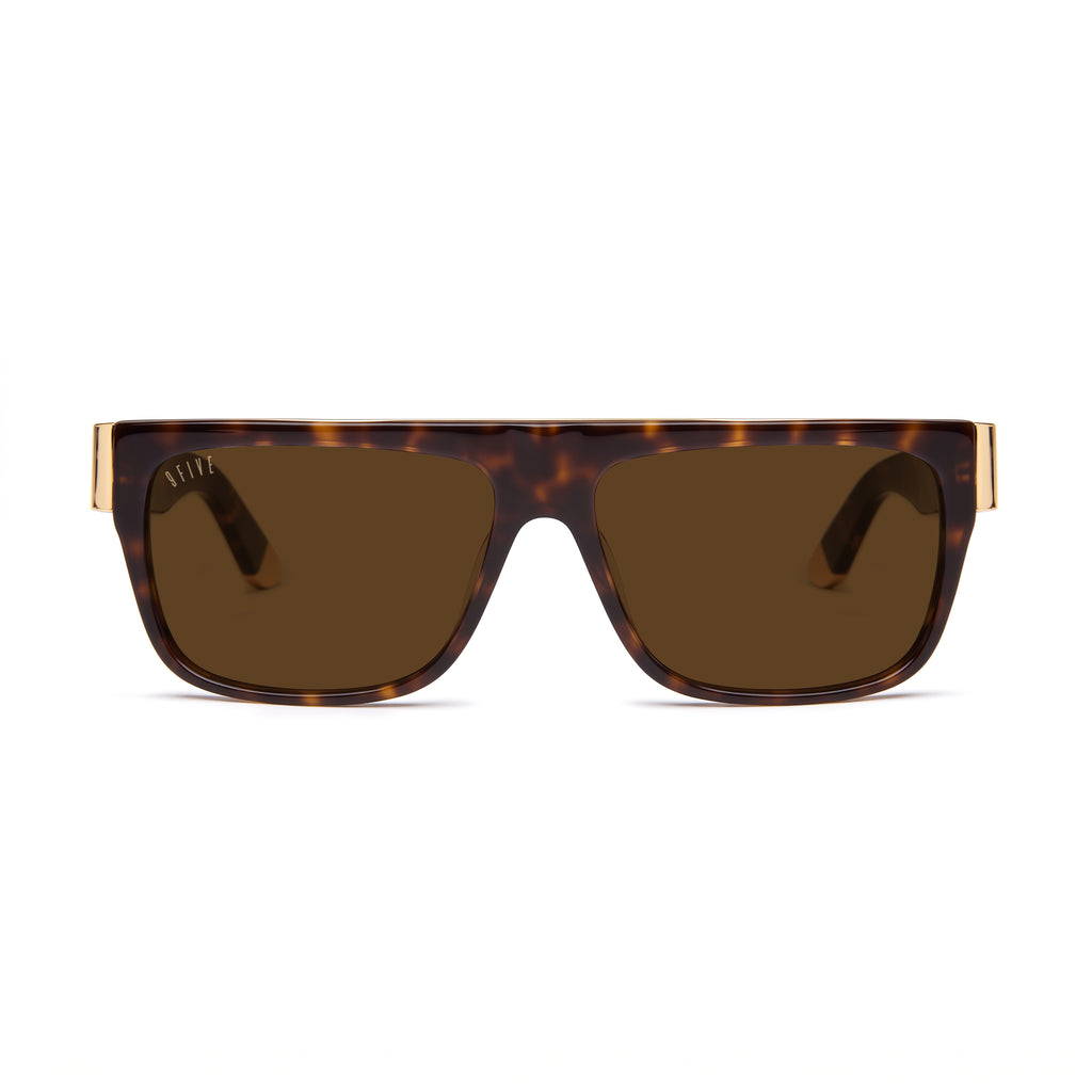 A pair of rectangula sunglasses with a dark brown and black tortoiseshell frame and dark brown lenses, featuring gold metal temples visible on the sides, set against a plain white background. [g:brown s:all o:1]