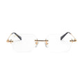 Rimless eyeglasses with clear lenses, gold metal bridge and hinges, and dark gray temple arms on a white background.