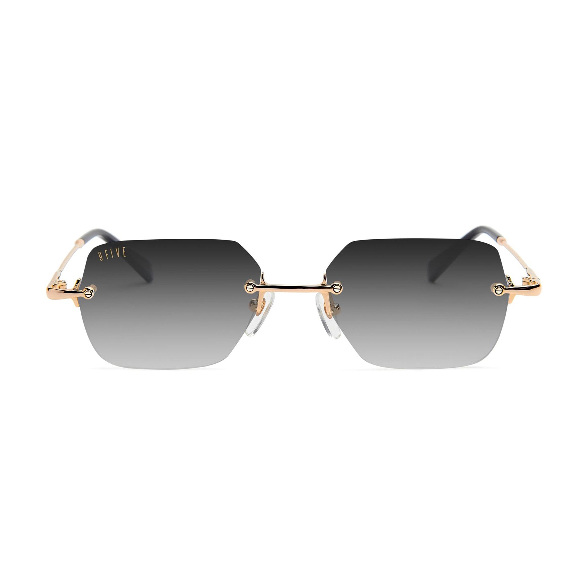 Rimless square sunglasses with gradient gray lenses, gold metal frames, and clear nose pads, shown against a plain white background.
[g:black-gradient s:all o:1]