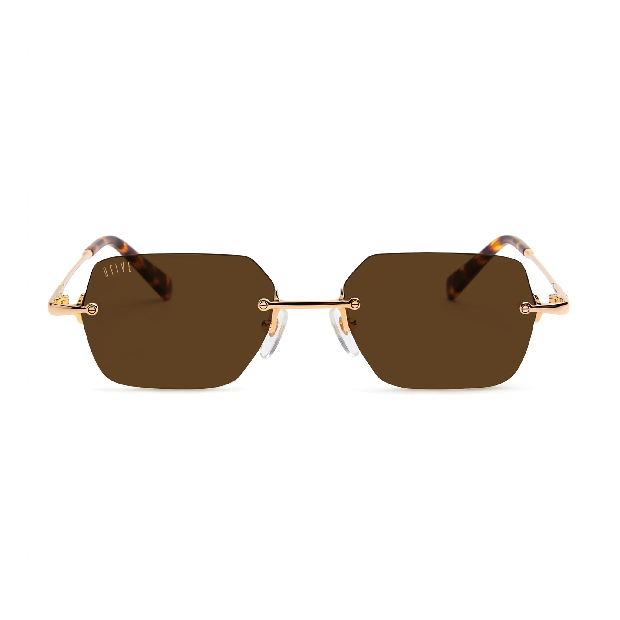Gold-framed sunglasses with dark lenses on a beige background [g:brown s:all o:1]