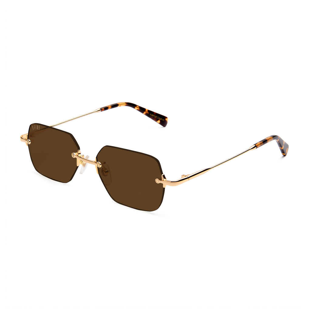 Sunglasses with dark lenses and thin metal frame on a white background
[g:brown s:all o:2]