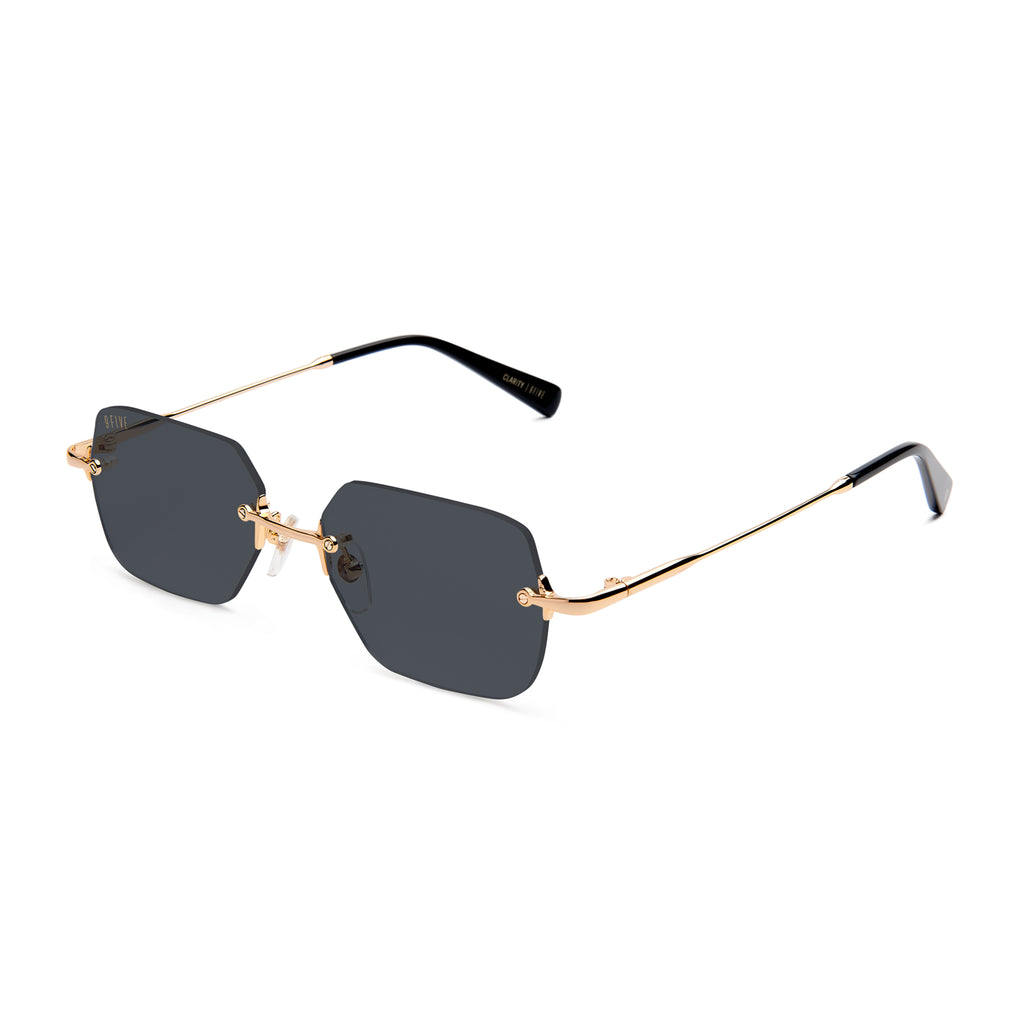 Rimless square sunglasses with dark gray lenses and a gold metal frame, displayed on a clean white background.
[g:black s:all o:2]
