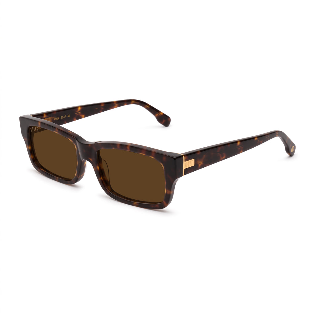 A pair of rectangular-frame sunglasses with a dark brown and black tortoiseshell pattern, brown lenses, and a small gold metal accent on the temple arm, shown against a plain white background. [g:brown s:all o:2]
