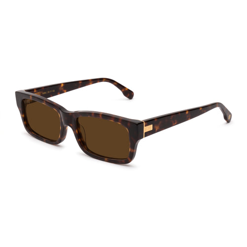 A pair of rectangular-frame sunglasses with a dark brown and black tortoiseshell pattern, brown lenses, and a small gold metal accent on the temple arm, shown against a plain white background. [g:brown s:all o:2]