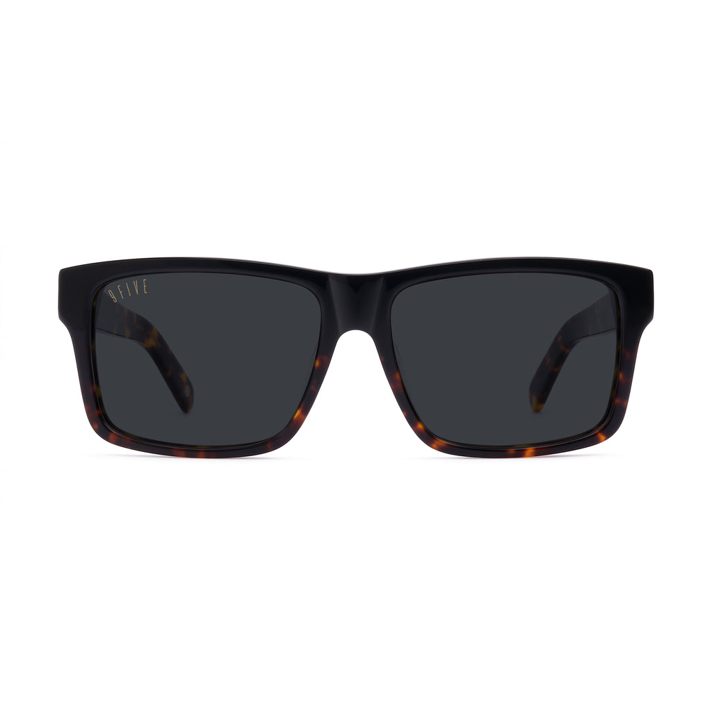 Square sunglasses with a glossy black front frame and dark lenses, featuring a subtle tortoiseshell pattern on the inner temples and a small gold '9five' logo on the upper left frame.
[g:black s:all o:1]