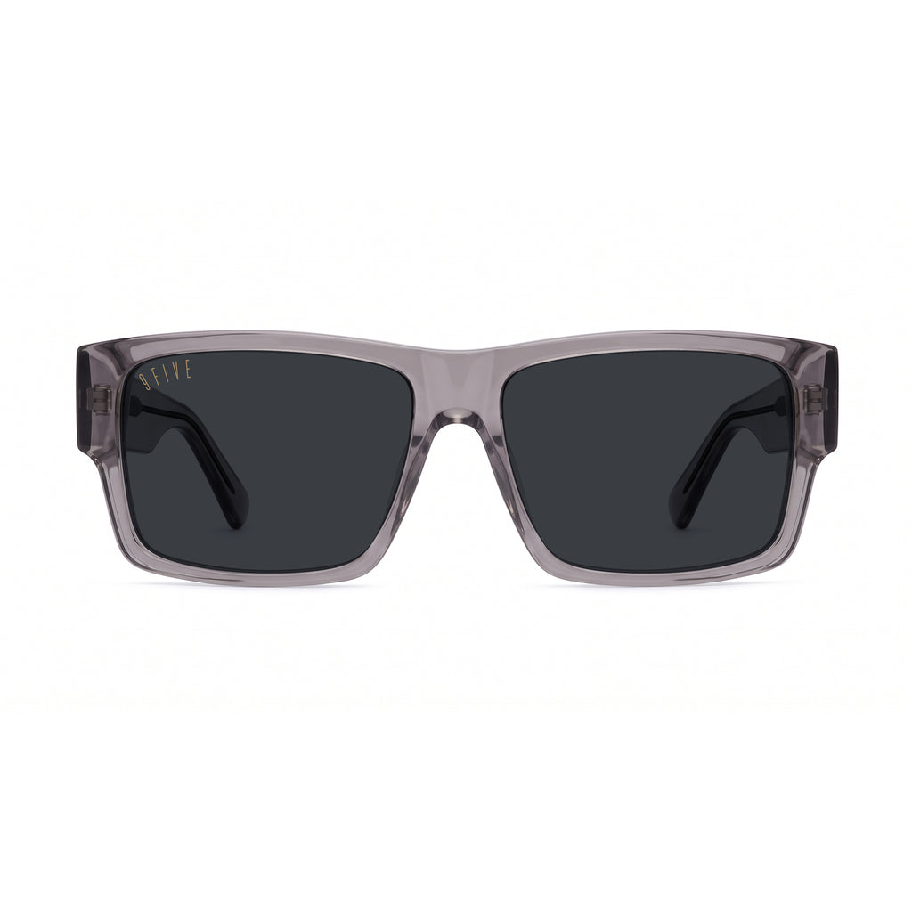 A pair of square sunglasses with a translucent smoky gray acetate frame and dark gray lenses, shown at a three-quarter angle on a plain white background.
[g:black s:all o:1]