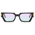 Black geometric square sunglasses with iridescent pastel gradient lenses and small gold metal accents on the temples, shown against a plain white background.[g:all s:all o:1]