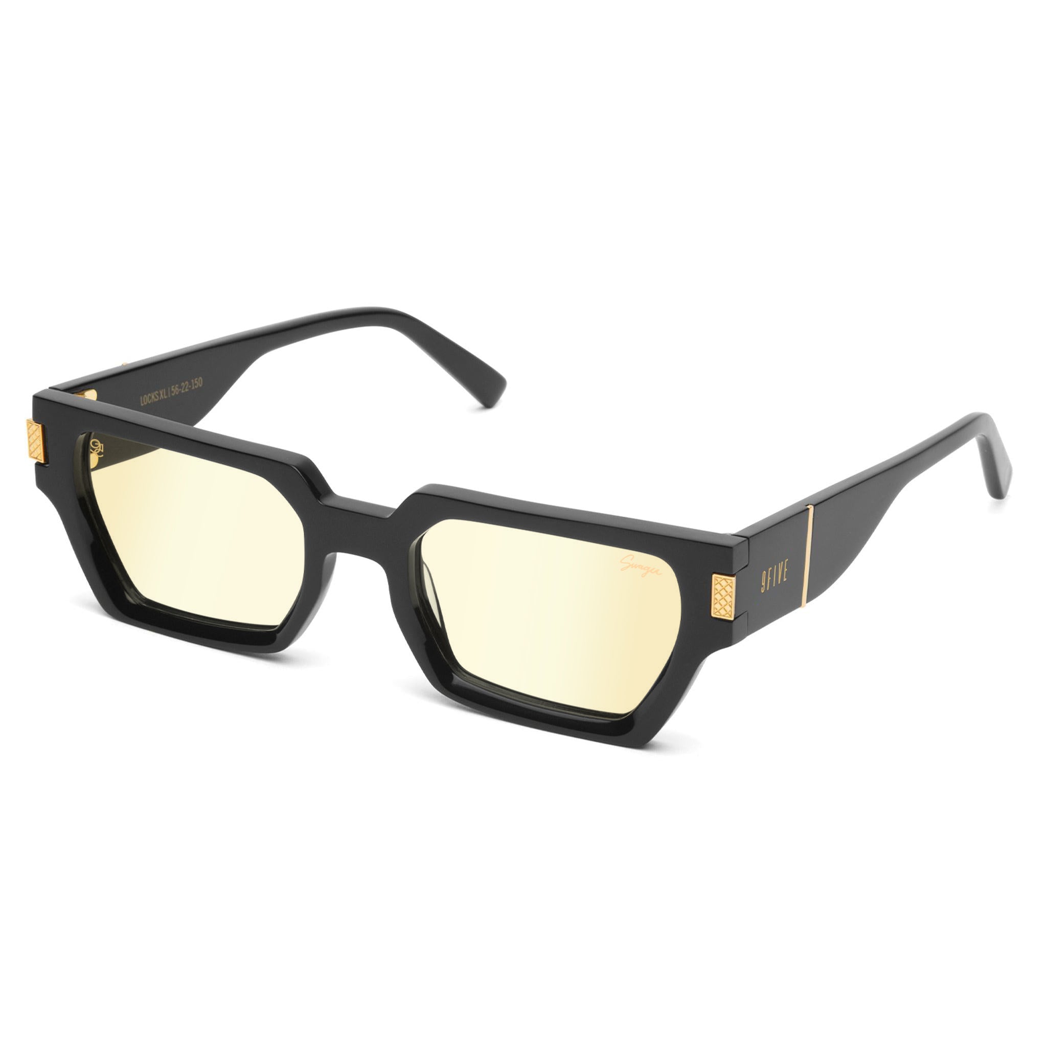 Black square sunglasses with light yellow lenses and gold-tone metal accents on the temples, shown on a plain white background. [g:all s:all o:2]