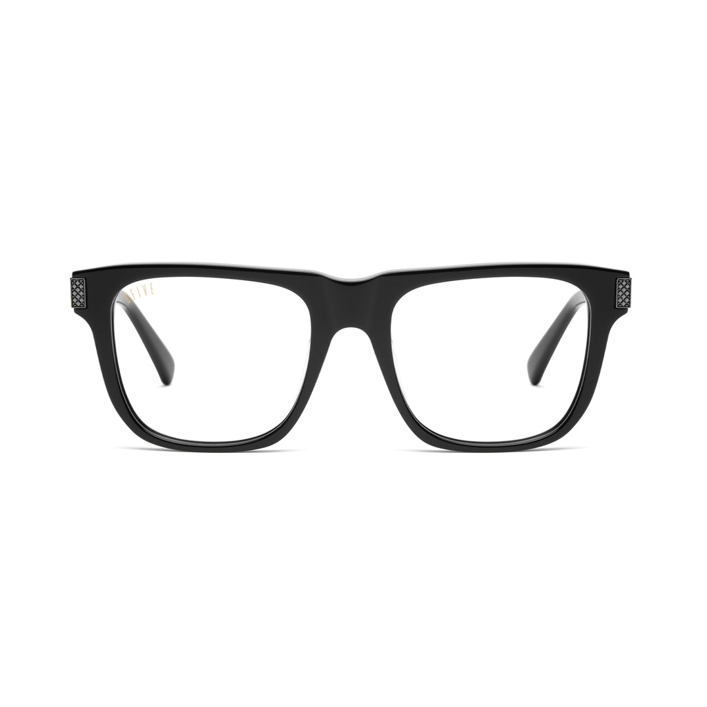 Black square eyeglass frames with clear lenses and small black-tone decorative details on the temples, shown against a plain white background. 9five black sunglasses on white background with black metal accents [g:clear s:all o:1]