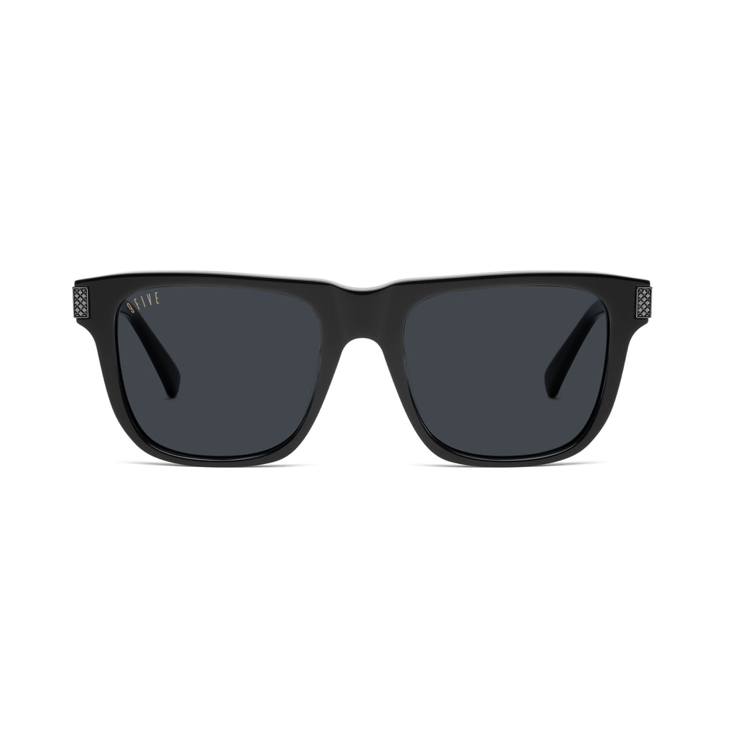 Black square sunglasses with dark gray lenses and small silver-tone logo details on the top corners of the frames, shown against a plain white background. 9five black sunglasses on white background with black metal accents [g:black s:all o:1]