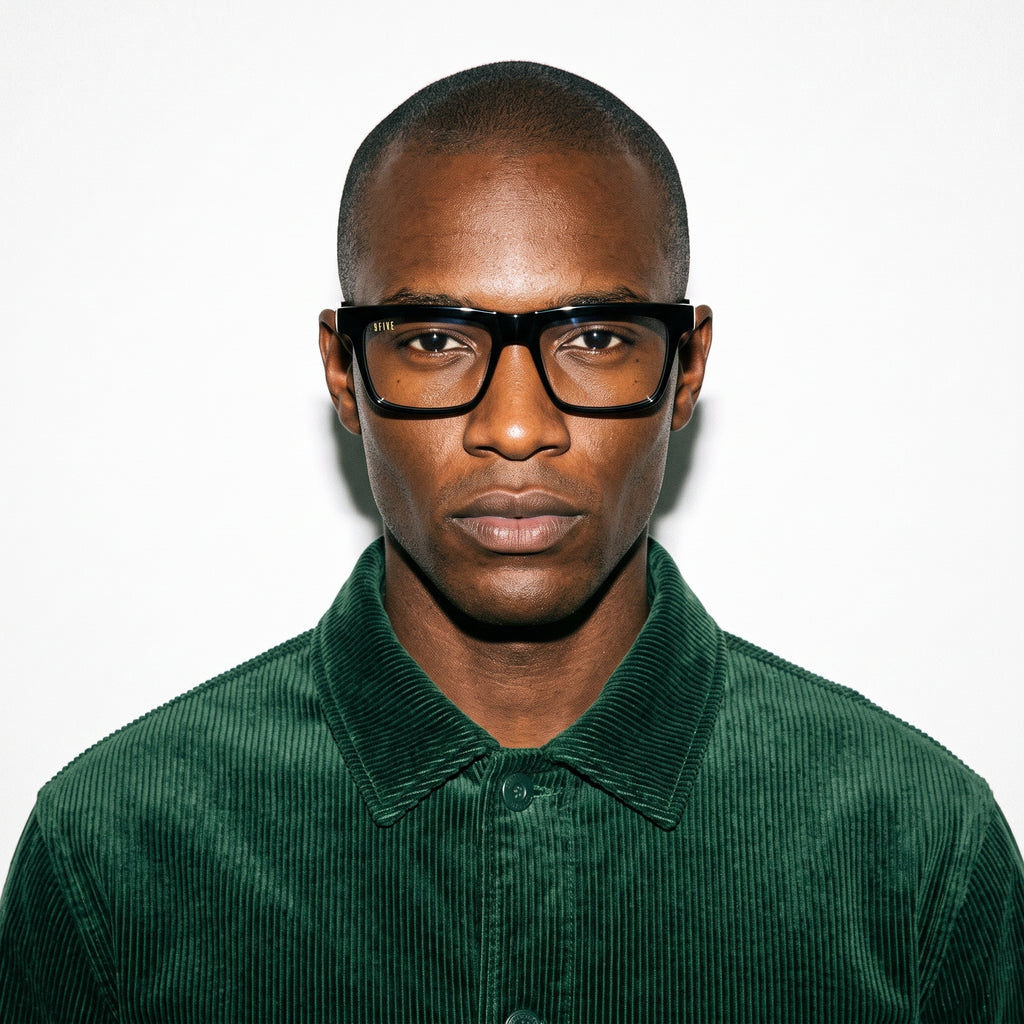 Man wearing black glasses and a green shirt against a white background [g:clear s:all o:3]