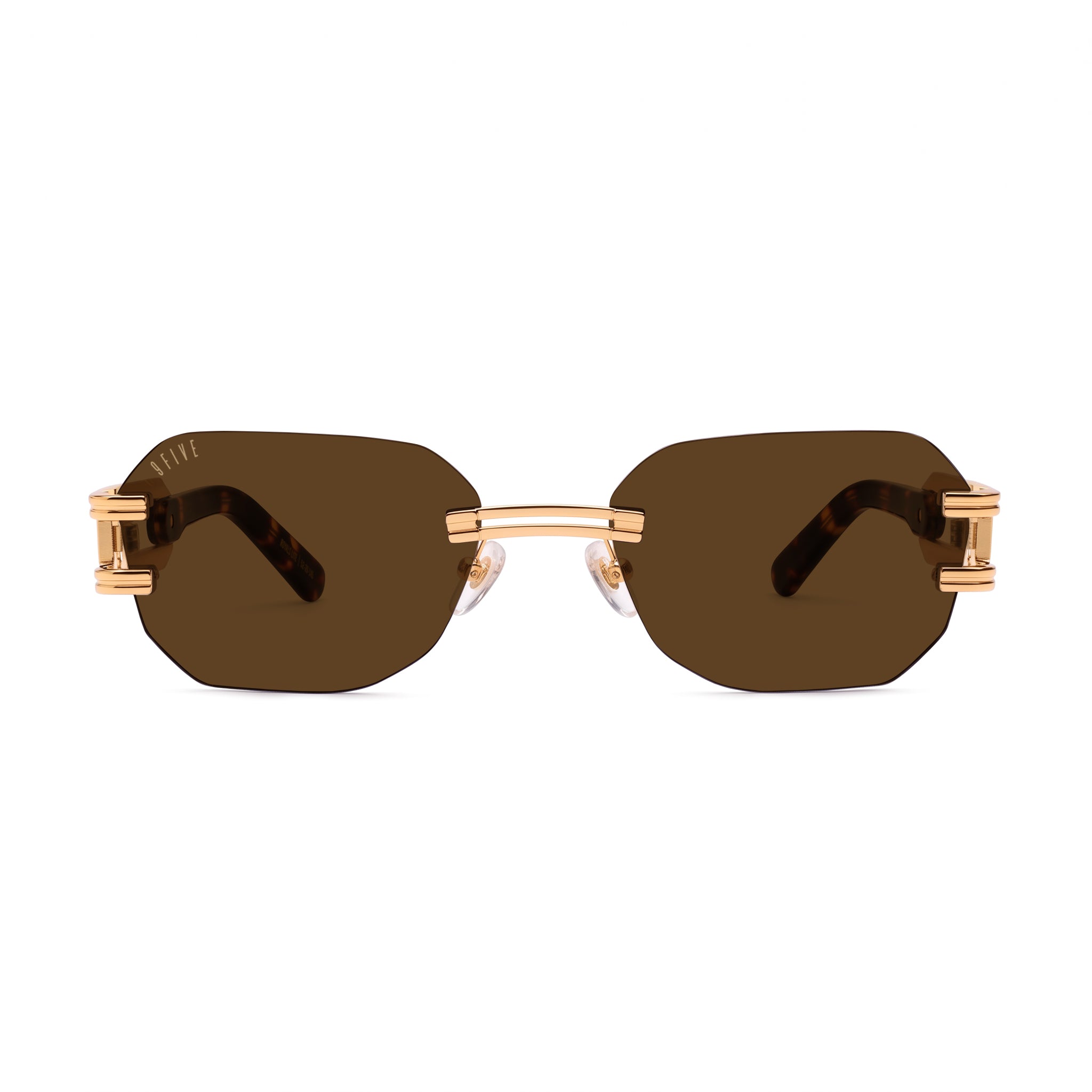 Rimless square sunglasses with dark brown lenses and gold metal frames, featuring decorative gold hardware on the temples, shown against a plain white background. [g:brown s:all o:1]