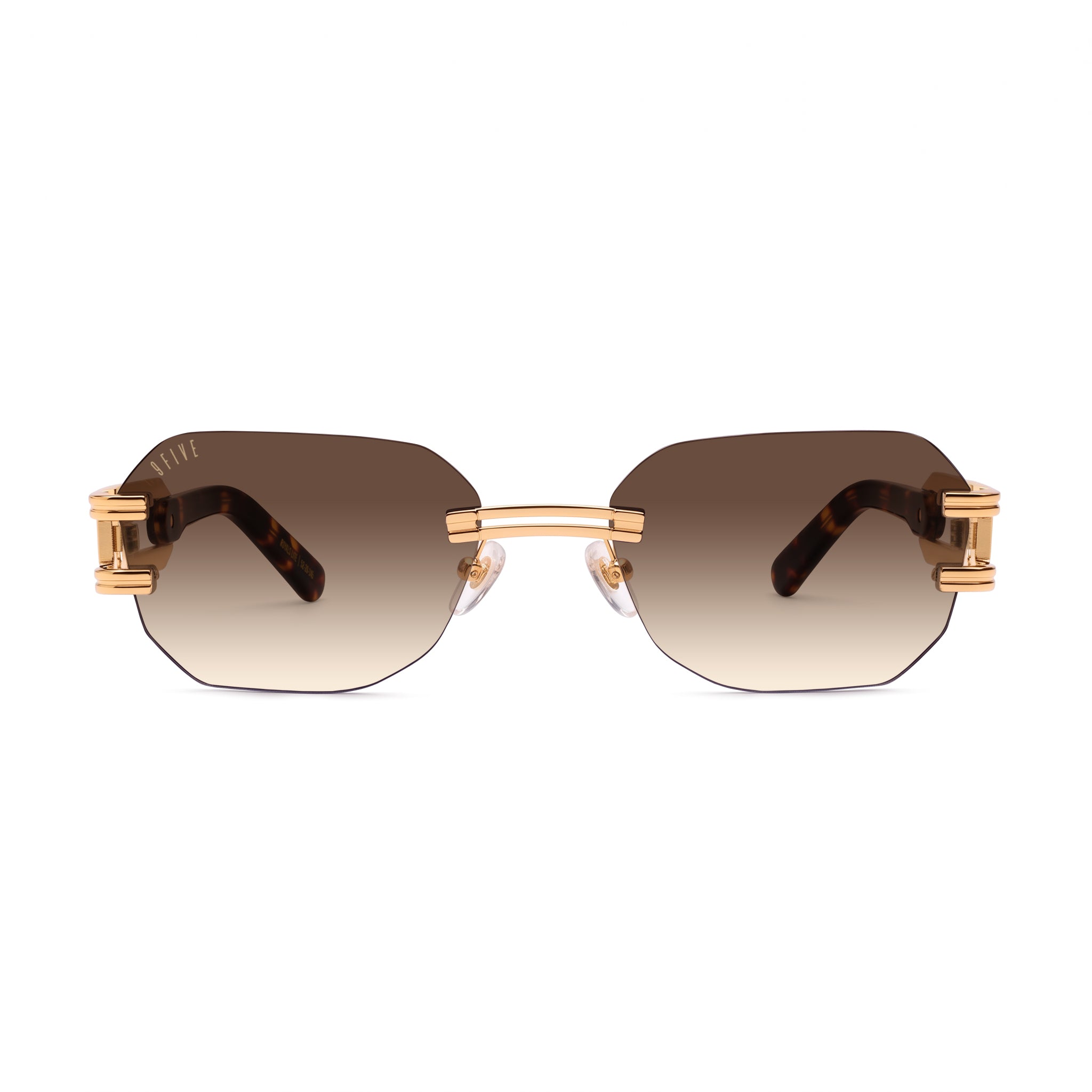 A pair of Rimless sunglasses with a gold metal frame, gradient brown lenses, and tortoiseshell temple arms, shown against a plain white background. [g:brown-gradient s:all o:1]