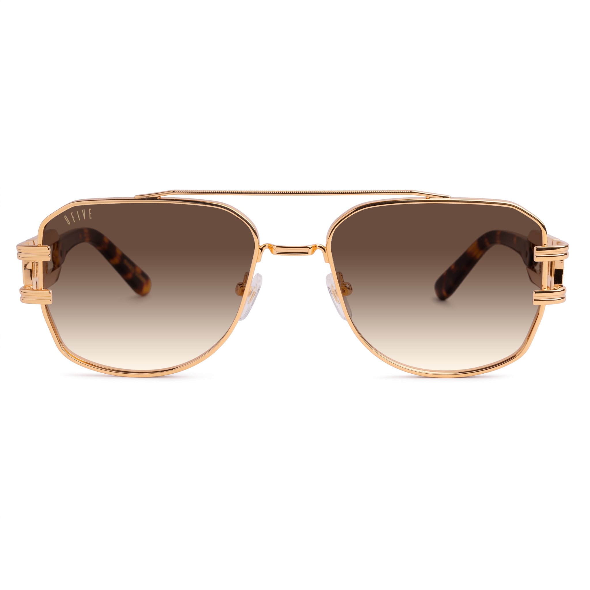 A pair of angular aviator-style sunglasses with a rose gold metal frame, brown lenses, and tortoiseshell temple arms, shown against a plain white background. [g:brown-gradient s:all o:1]