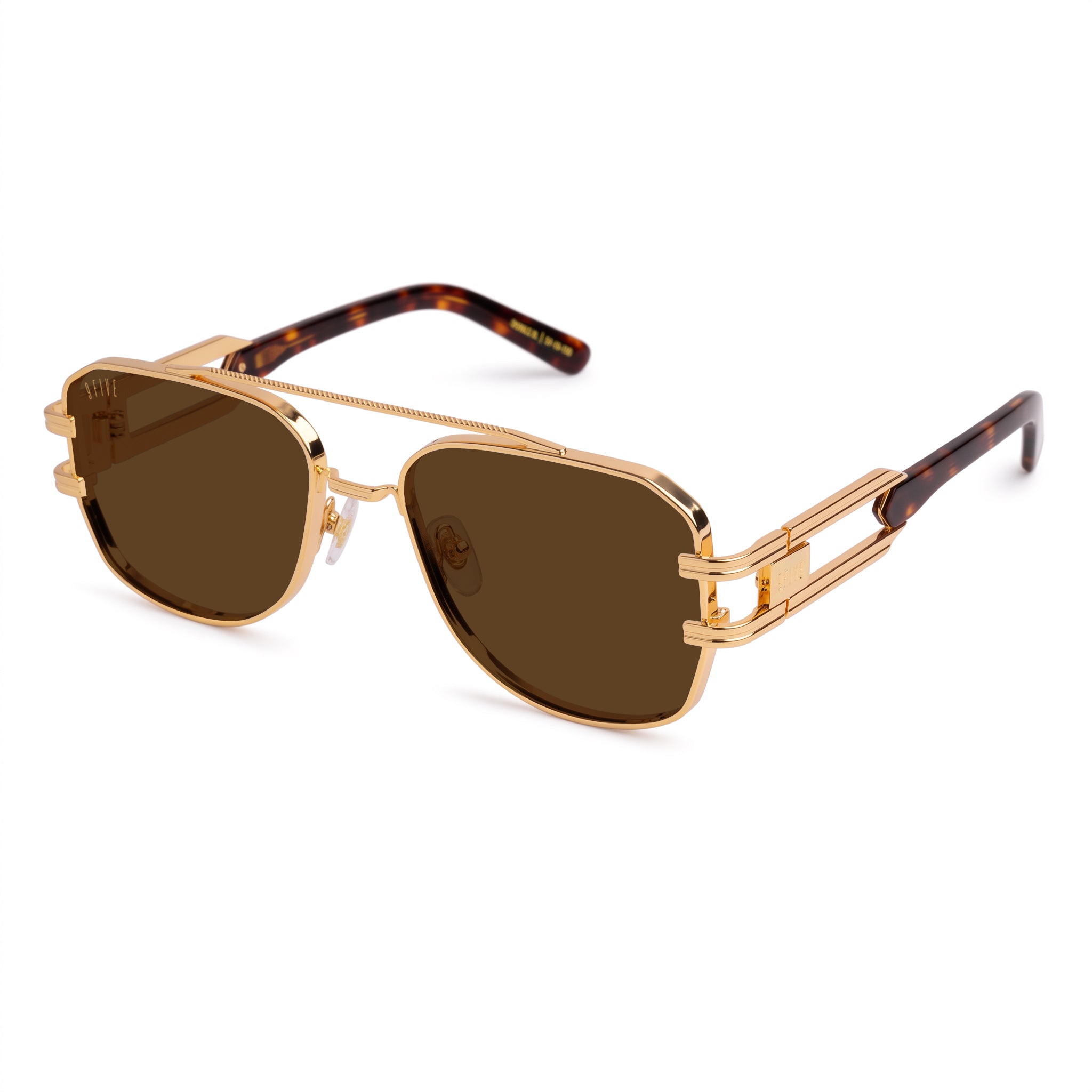 A pair of angular aviator-style sunglasses with a rose gold metal frame, brown lenses, and tortoiseshell temple arms, shown against a plain white background. [g:brown s:all o:2]