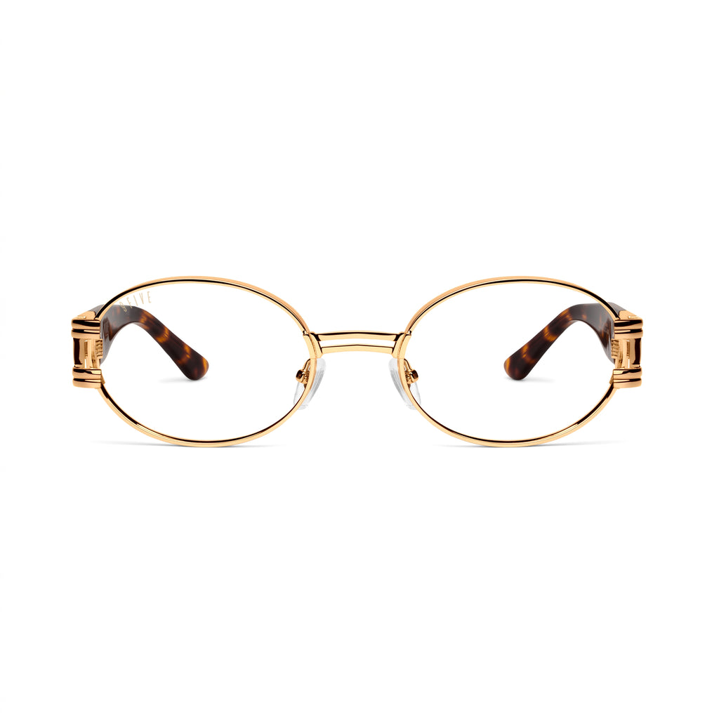 Oval eyeglasses with a gold metal frame and tortoiseshell temple arms, shown from the front on a white background. [g:clear s:all o:1]