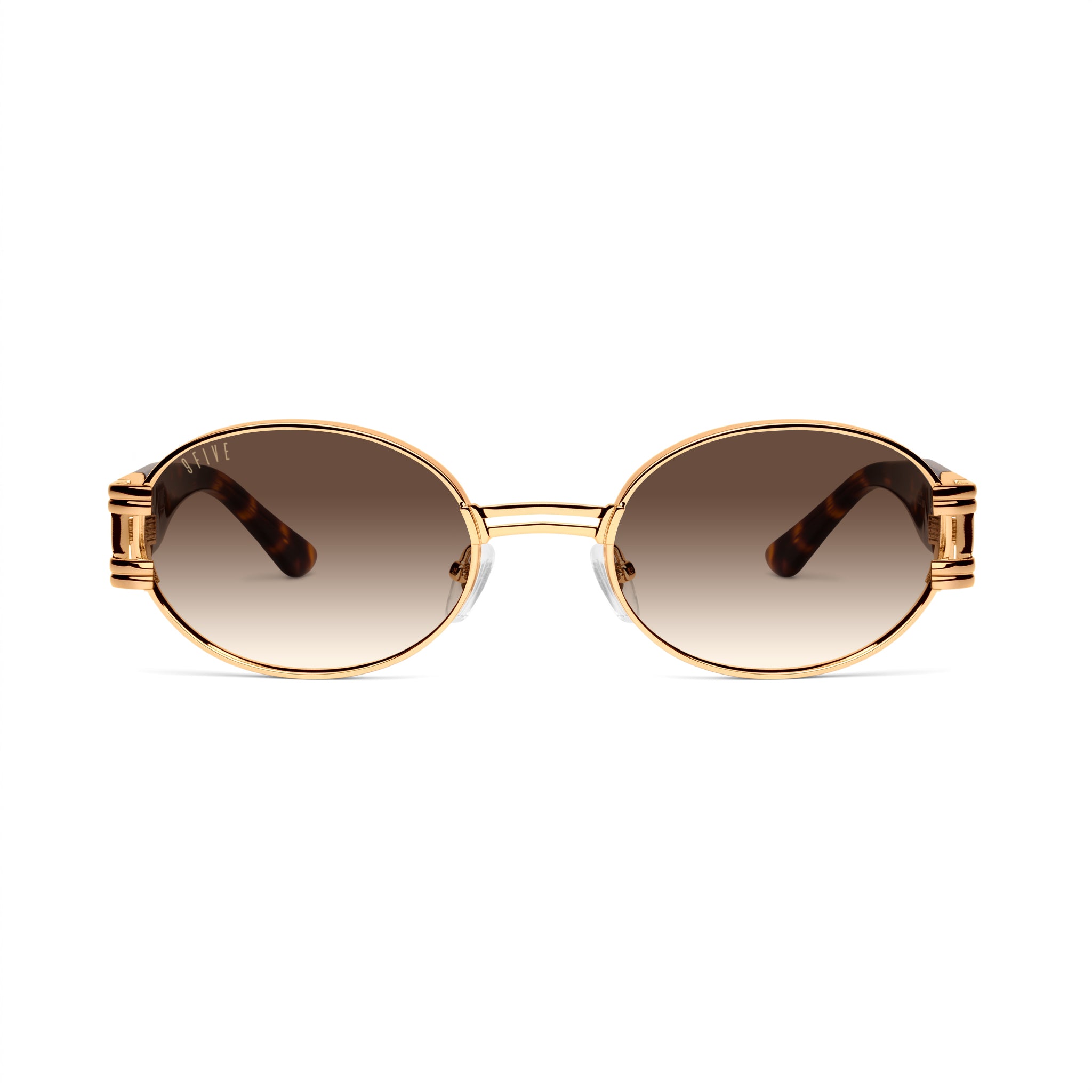 Oval sunglasses with gold metal frames, brown gradient lenses, and tortoiseshell acetate temples, shown on a clean white background. [g:brown-gradient s:all o:1]