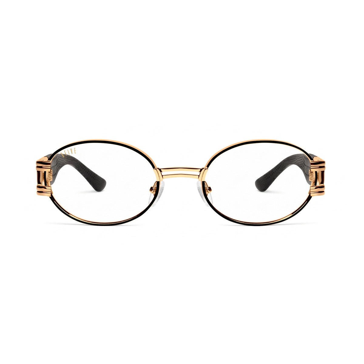 Oval sunglasses with clear lenses, a gold metal frame, and black temple tips, shown against a plain white background.[g:clear s:all o:1]