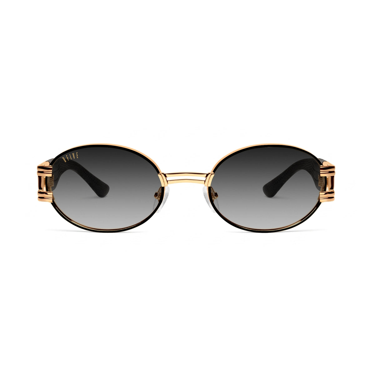 Oval sunglasses with dark lenses, a gold metal frame, and black temple tips, shown against a plain white background.[g:black-gradient s:all o:1]