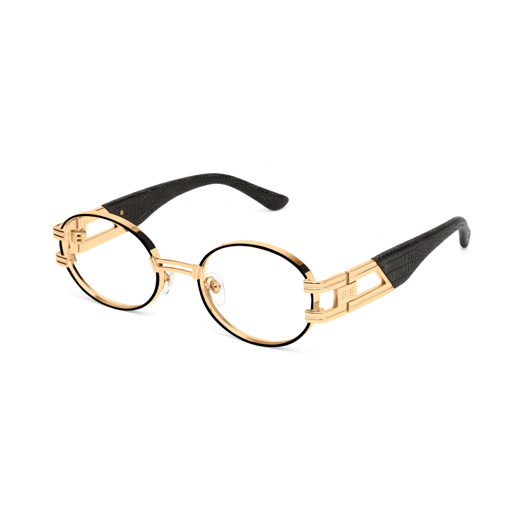 Oval sunglasses with clear lenses, a gold metal frame, and black temple tips, shown against a plain white background.[g:clear s:all o:2]