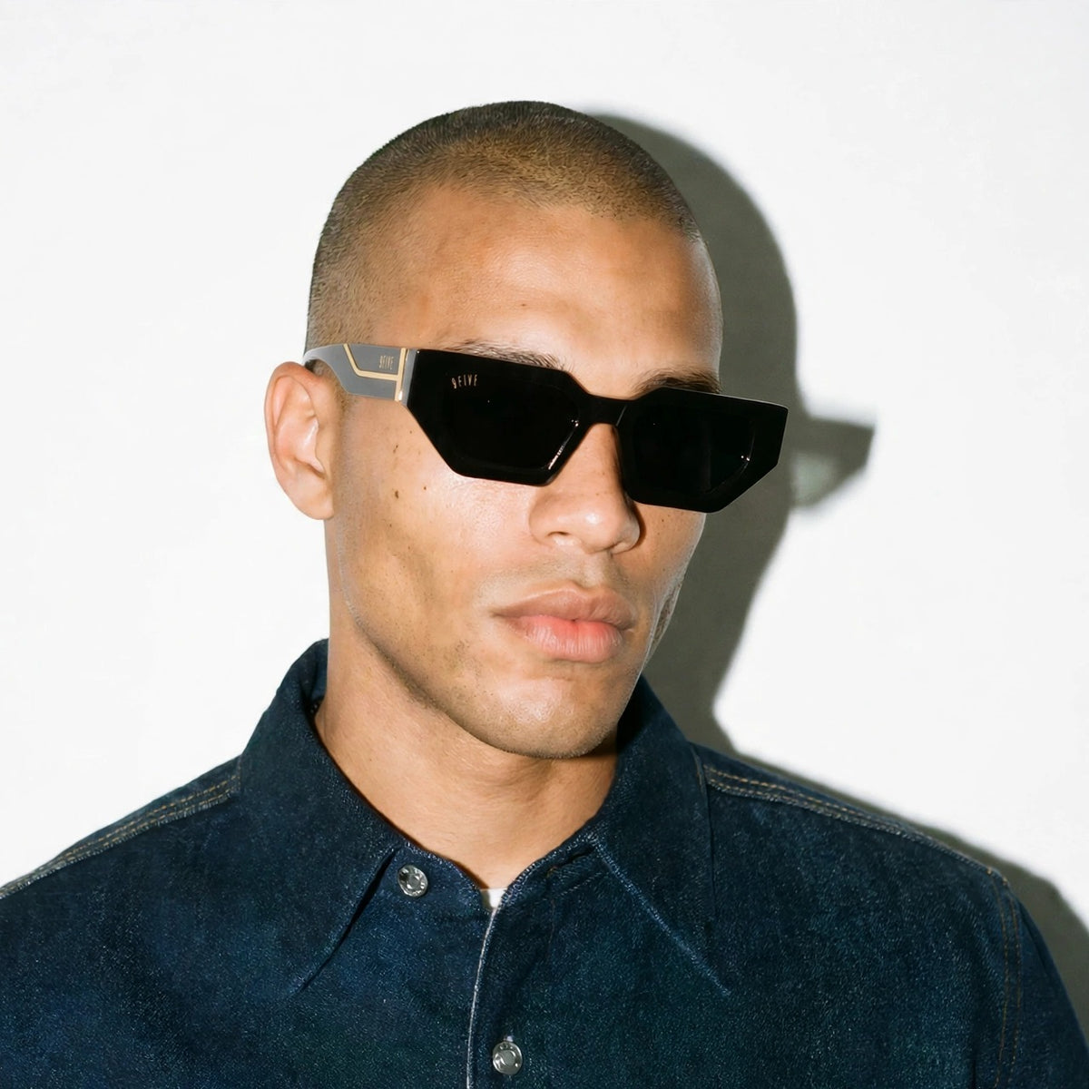Vincent Black 24K Gold sunglasses worn on model [g:black s:all o:3]